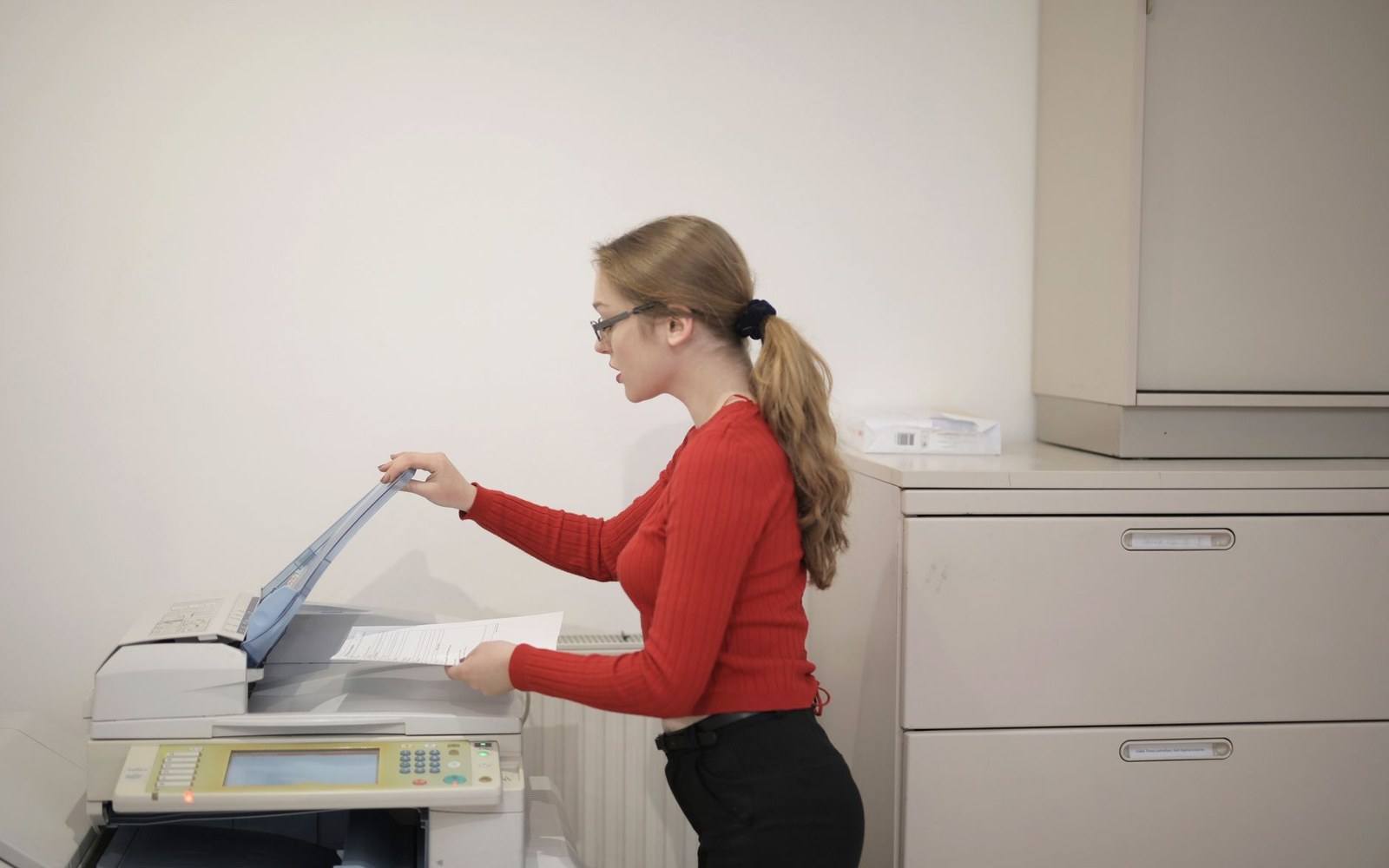 a photocopier lid raised, platen glass lit